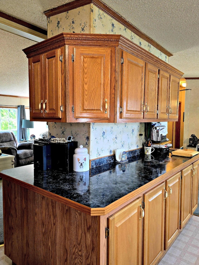 106 Hazel St, Saint Ignace, MI 49781 - kitchen with a textured ceiling, crown molding, brown cabinets, dark countertops, and open floor plan