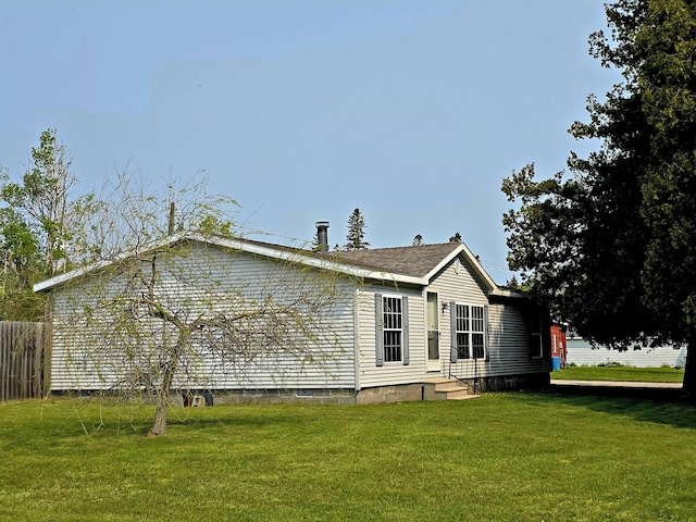 106 Hazel St, Saint Ignace, MI 49781 - view of home's exterior featuring a lawn