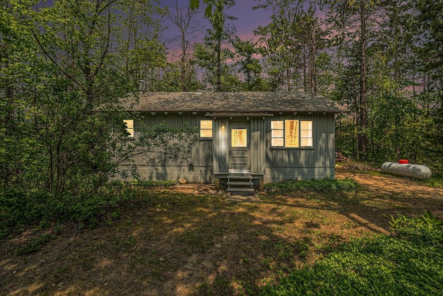 2080 Tomahawk Trl, Gaylord, MI 49735 - view of front facade with a shingled roof, board and batten siding, and entry steps