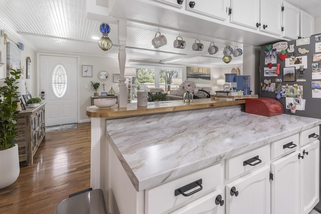 217 Cherry St, Houghton Lake, MI 48629 - kitchen with dark wood-style floors, white cabinets, light stone counters, and open floor plan