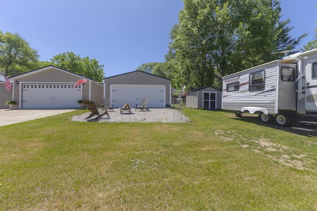 217 Cherry St, Houghton Lake, MI 48629 - view of green lawn featuring a garage and a storage shed