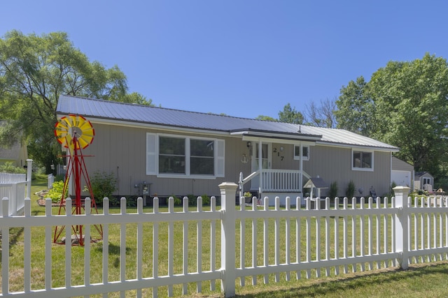 217 Cherry St, Houghton Lake, MI 48629 - ranch-style home with a fenced front yard and a metal roof