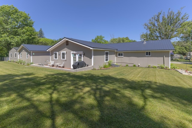 217 Cherry St, Houghton Lake, MI 48629 - rear view of property featuring a metal roof and a yard