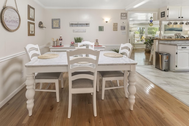 217 Cherry St, Houghton Lake, MI 48629 - dining space featuring ornamental molding and light wood finished floors