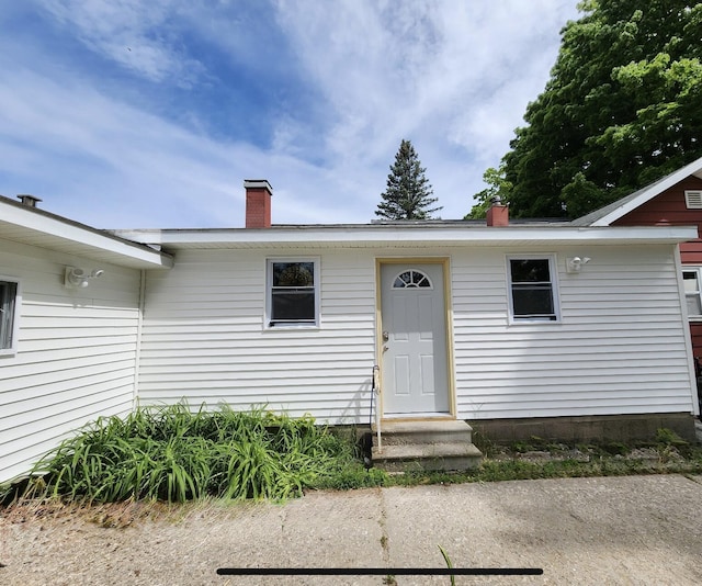 3134 Kneeland St, Lewiston, MI 49756 - view of front facade featuring entry steps and a chimney