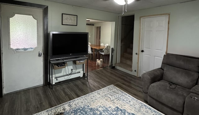 3134 Kneeland St, Lewiston, MI 49756 - living room with wood finished floors, a baseboard heating unit, and a ceiling fan