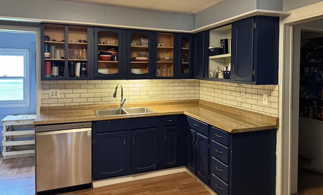 3134 Kneeland St, Lewiston, MI 49756 - bar area with stainless steel dishwasher, a sink, wood finished floors, and decorative backsplash