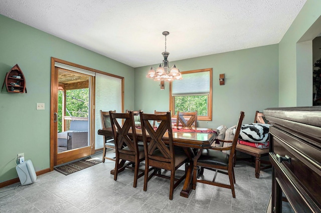 10702 Southwood Dr, Mancelona, MI 49659 - dining space with a chandelier, baseboards, and a textured ceiling