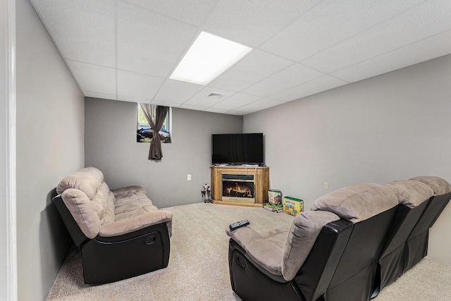 10702 Southwood Dr, Mancelona, MI 49659 - living room with carpet flooring, a drop ceiling, and a glass covered fireplace