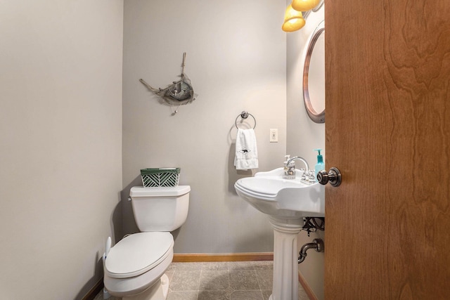10702 Southwood Dr, Mancelona, MI 49659 - half bathroom featuring tile patterned flooring, toilet, and baseboards