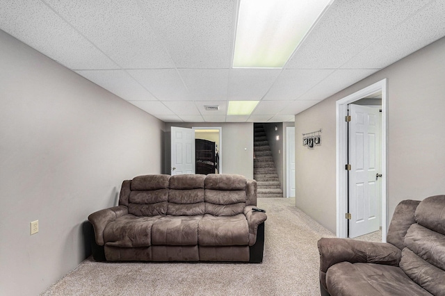 10702 Southwood Dr, Mancelona, MI 49659 - living area featuring carpet flooring, a paneled ceiling, and stairway