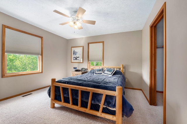 10702 Southwood Dr, Mancelona, MI 49659 - bedroom featuring carpet floors, baseboards, a ceiling fan, and a textured ceiling