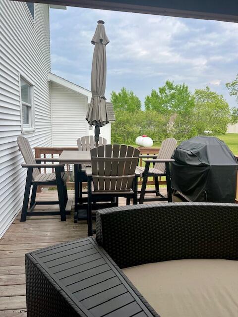 10702 Southwood Dr, Mancelona, MI 49659 - wooden deck featuring outdoor dining space