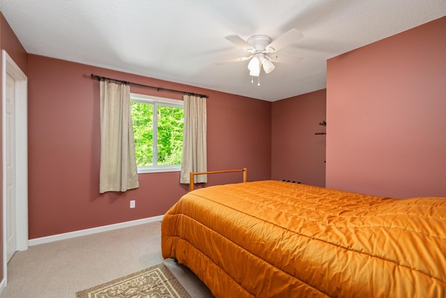 11193 Hassler Woods Trl, Alanson, MI 49706 - bedroom featuring carpet flooring, baseboards, and a ceiling fan