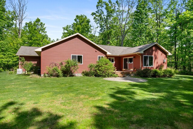 11193 Hassler Woods Trl, Alanson, MI 49706 - view of front of house featuring a front yard and a shingled roof