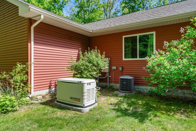 11193 Hassler Woods Trl, Alanson, MI 49706 - exterior view of a power unit, cooling unit, a downspout, and gutters