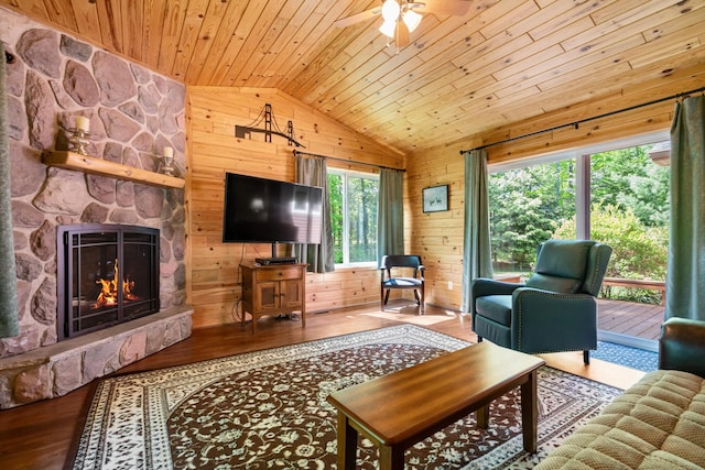 11193 Hassler Woods Trl, Alanson, MI 49706 - living area featuring lofted ceiling, wood ceiling, wooden walls, wood finished floors, and a ceiling fan