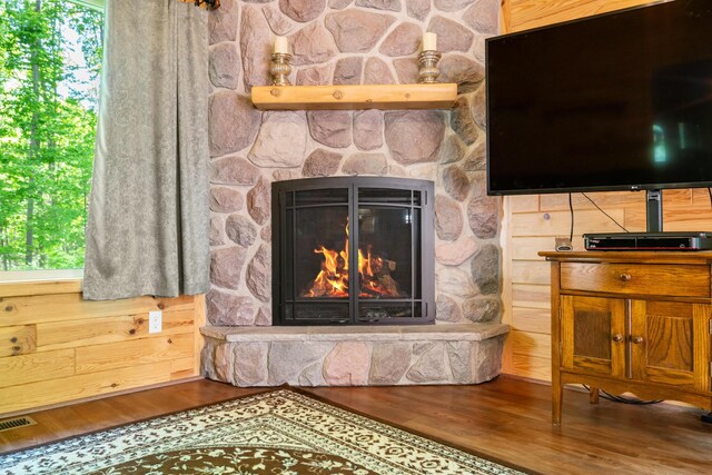 11193 Hassler Woods Trl, Alanson, MI 49706 - detailed view of wood finished floors and a stone fireplace