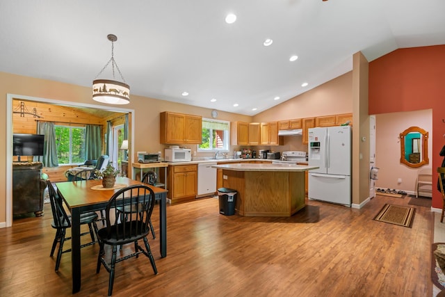 11193 Hassler Woods Trl, Alanson, MI 49706 - kitchen featuring white appliances, light countertops, under cabinet range hood, a kitchen island, and wood finished floors