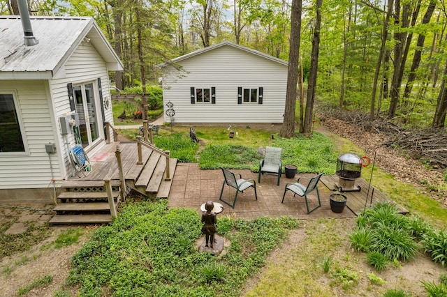 7106 Douglas Lake Rd, Johannesburg, MI 49751 - view of yard with a wooden deck, a fire pit, french doors, and a patio