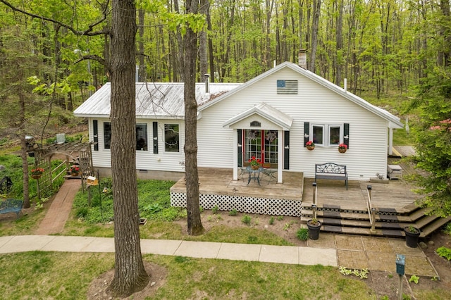 7106 Douglas Lake Rd, Johannesburg, MI 49751 - view of front of property with a wooden deck, a view of trees, metal roof, and crawl space