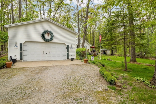 7106 Douglas Lake Rd, Johannesburg, MI 49751 - view of side of property featuring a garage and view of wooded area