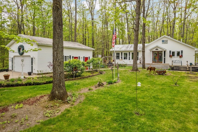 7106 Douglas Lake Rd, Johannesburg, MI 49751 - view of green lawn with a wooden deck and a detached garage