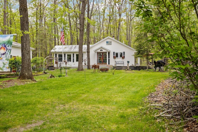 7106 Douglas Lake Rd, Johannesburg, MI 49751 - view of front of home with a deck and a front lawn