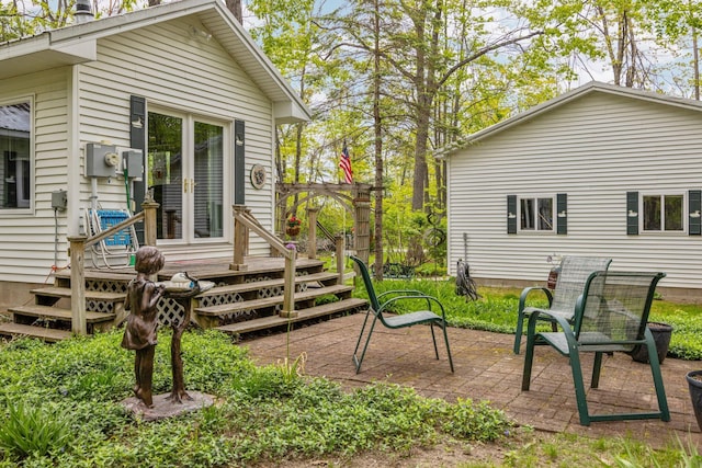 7106 Douglas Lake Rd, Johannesburg, MI 49751 - view of yard featuring a wooden deck and a patio