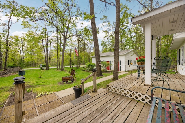 7106 Douglas Lake Rd, Johannesburg, MI 49751 - wooden terrace featuring a yard, outdoor dining area, and an outdoor structure
