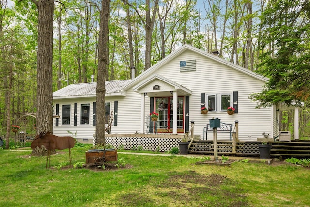 7106 Douglas Lake Rd, Johannesburg, MI 49751 - rear view of property featuring a wooden deck, a yard, crawl space, and metal roof