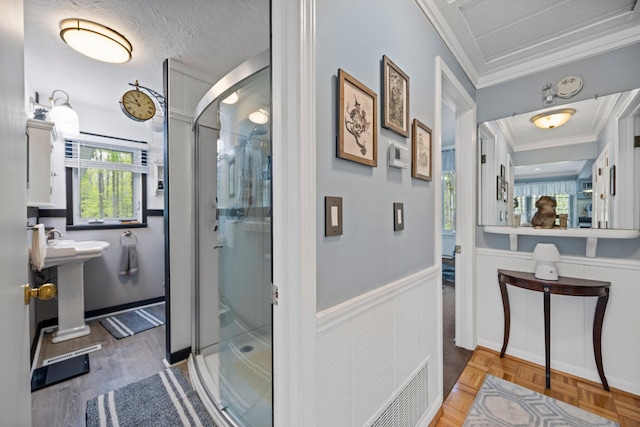 7106 Douglas Lake Rd, Johannesburg, MI 49751 - bathroom with ornamental molding, a stall shower, and wainscoting