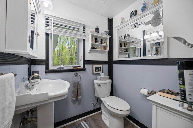 7106 Douglas Lake Rd, Johannesburg, MI 49751 - half bath featuring wood finished floors and toilet