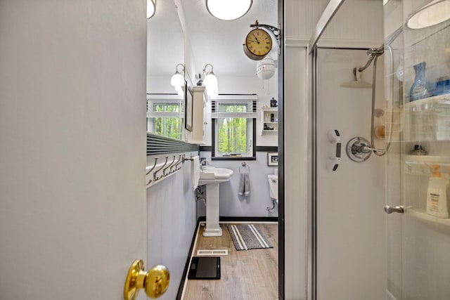 7106 Douglas Lake Rd, Johannesburg, MI 49751 - bathroom with a stall shower and wood finished floors