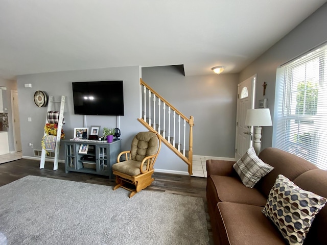 2476 W Branch Dr, West Branch, MI 48661 - living room featuring stairway, wood finished floors, and baseboards