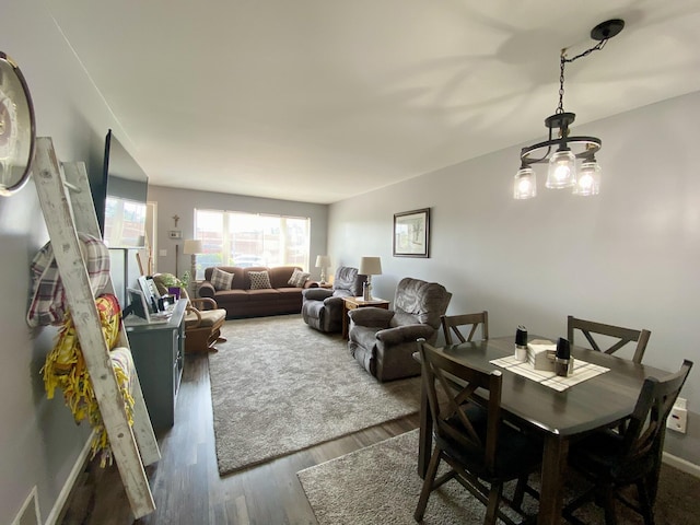 2476 W Branch Dr, West Branch, MI 48661 - dining area with dark wood-style floors and baseboards