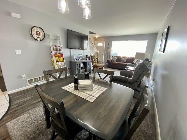 2476 W Branch Dr, West Branch, MI 48661 - dining room with stairway, wood finished floors, and baseboards