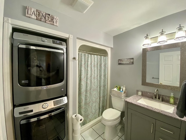 2476 W Branch Dr, West Branch, MI 48661 - bathroom with stacked washer / dryer, vanity, toilet, tile patterned floors, and a shower with shower curtain