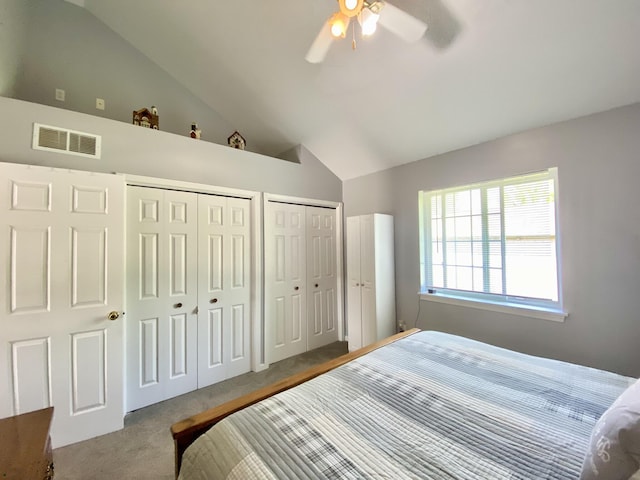 2476 W Branch Dr, West Branch, MI 48661 - carpeted bedroom featuring vaulted ceiling, two closets, and ceiling fan