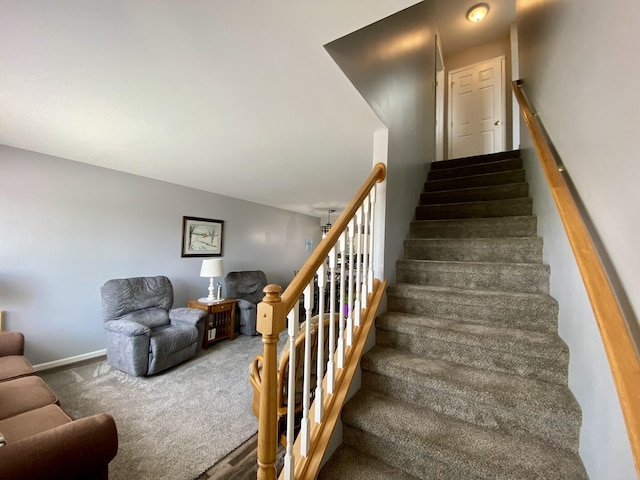 2476 W Branch Dr, West Branch, MI 48661 - staircase featuring carpet flooring and baseboards
