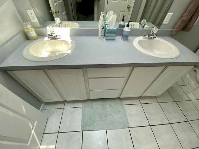 2476 W Branch Dr, West Branch, MI 48661 - bathroom featuring double vanity and tile patterned flooring
