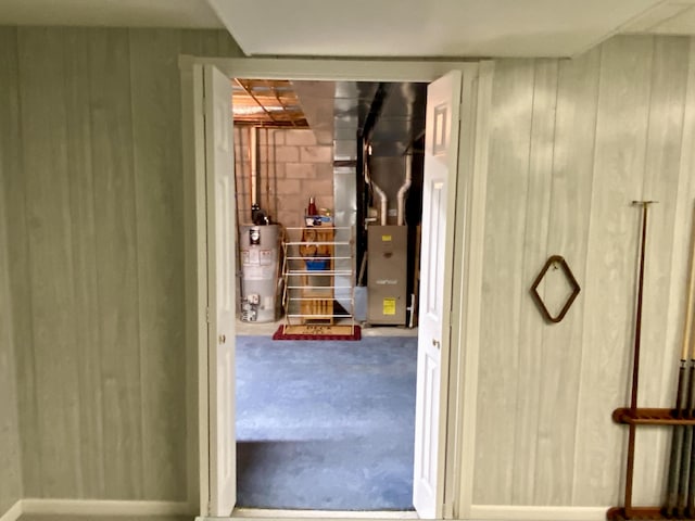 2476 W Branch Dr, West Branch, MI 48661 - hall featuring water heater, heating unit, and wooden walls