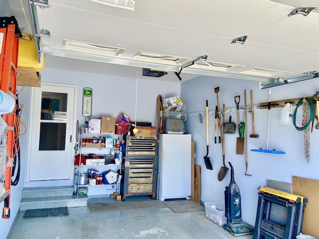 2476 W Branch Dr, West Branch, MI 48661 - garage featuring a garage door opener