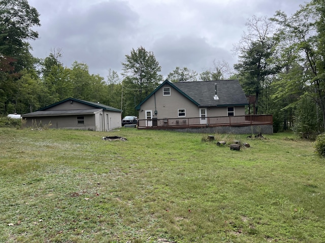 7781 N M-18, Roscommon, MI 48653 - rear view of property with an outdoor fire pit, a wooden deck, and a yard