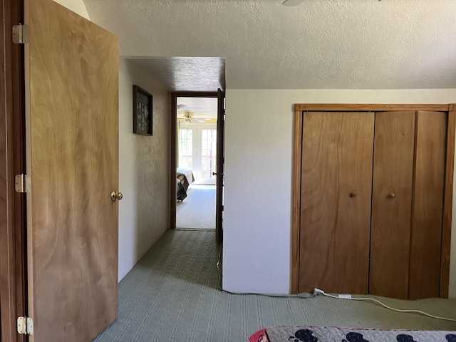 7781 N M-18, Roscommon, MI 48653 - unfurnished bedroom with carpet, a textured ceiling, and a closet