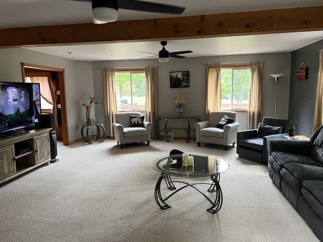 7781 N M-18, Roscommon, MI 48653 - living room featuring carpet flooring, plenty of natural light, ceiling fan, beamed ceiling, and baseboards