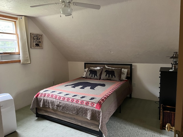 7781 N M-18, Roscommon, MI 48653 - bedroom with a textured ceiling, lofted ceiling, a ceiling fan, and carpet floors