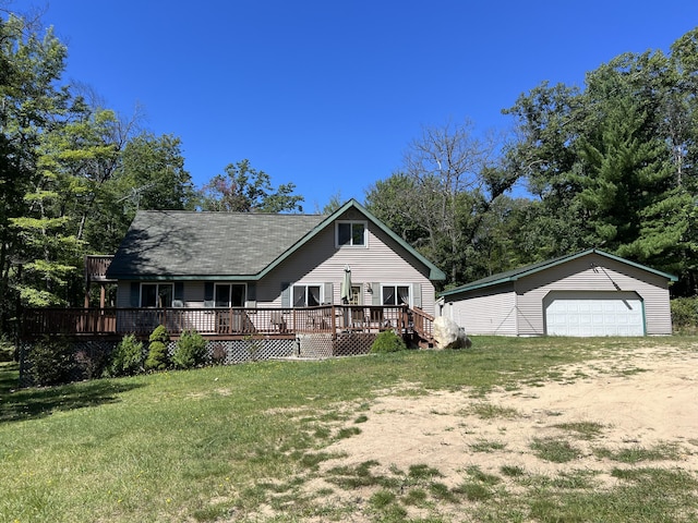 7781 N M-18, Roscommon, MI 48653 - view of front of home featuring an outdoor structure, a deck, a detached garage, a front lawn, and driveway