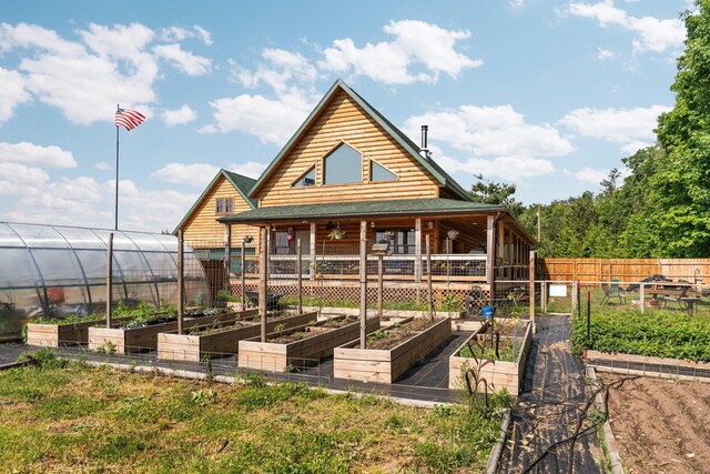 8406 S Shire Rd, Vanderbilt, MI 49795 - rear view of property featuring a vegetable garden and ceiling fan