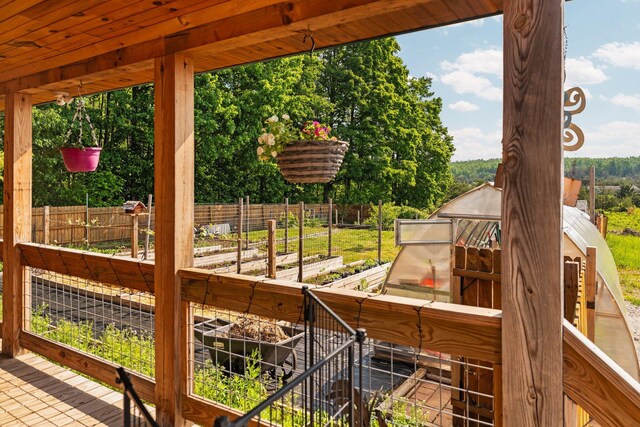 8406 S Shire Rd, Vanderbilt, MI 49795 - wooden deck with a garden